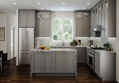 Large light gray RTA shaker kitchen with stacked glass cabinets and center island