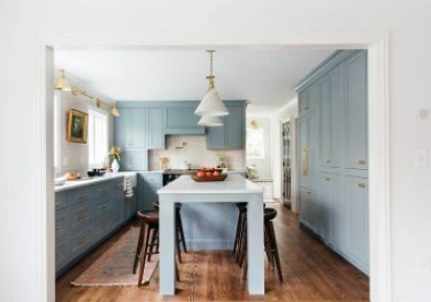 Large L-shaped shaker kitchen design in blue-gray paint finish with large farm-style kitchen island