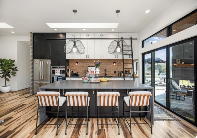 White and black slab door kitchen design with gray countertops and eclectic details