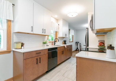 White and natural wood slab kitchen cabinets with white subway tile backsplash