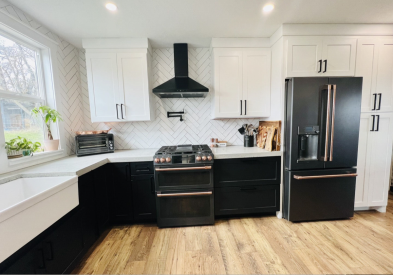 Modern white and black shaker kitchen design with white quartz countertops and black and gold appliances