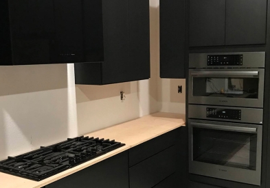 Black slab CliqStudios kitchen cabinets