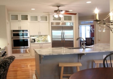 Photo gallery of remodeled kitchen features CliqStudios Shaker Painted White cabinets. Deluxe panels on large center island provide finishing touch