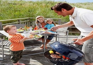 family grilling outside forest