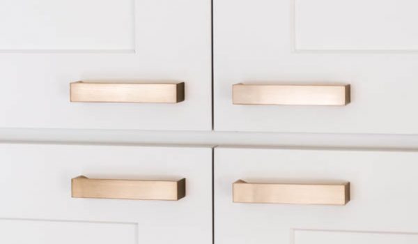 four gold cabinet hardware door pulls on white cabinets