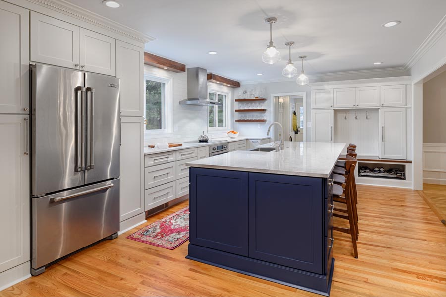 two-tone kitchen with white cabinetry and blue kitchen island