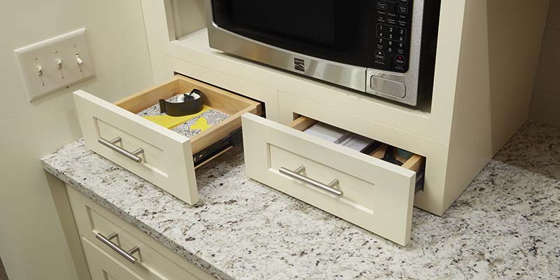 Wall furniture drawers underneath a microwave shelf, styled in Shaker, Painted Cream.