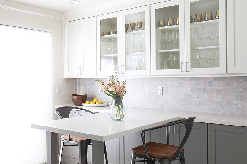 A gray and white two-toned kitchen using CliqStudios Shaker cabinets in White and Medium Gray.