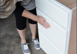 Woman looking at a CliqStudios cabinet drawer fronts.