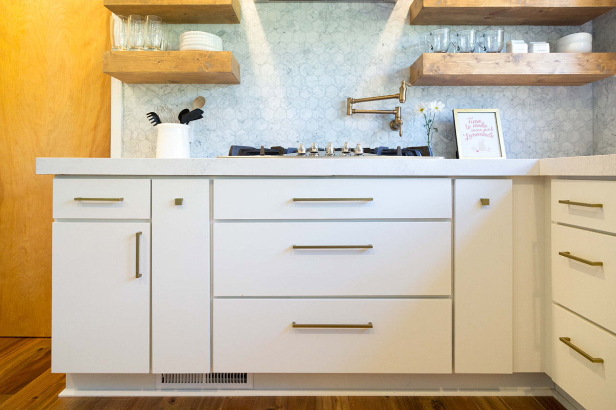 Here, the top drawer pulls are centered while the bottom pulls are raised. The distance from the drawer's top edge to the handlebar is equal for all drawers.