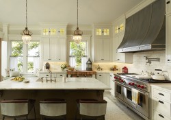 a traditional kitchne style white inset cabinetry kitchen island