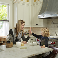 Mom and child in remodeled white kitchen in St Paul 