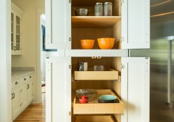 Kitchen remodeling project features CliqStudios.com inset cabinets in the Shaker Inset cabinet style in a painted White finish. Features include this built-in tall pantry cabinet with slide-out shelves for easy-reach storage and organization.