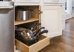 Kitchen using CliqStudios Shaker Inset painted White cabinets with roll-out drawers.