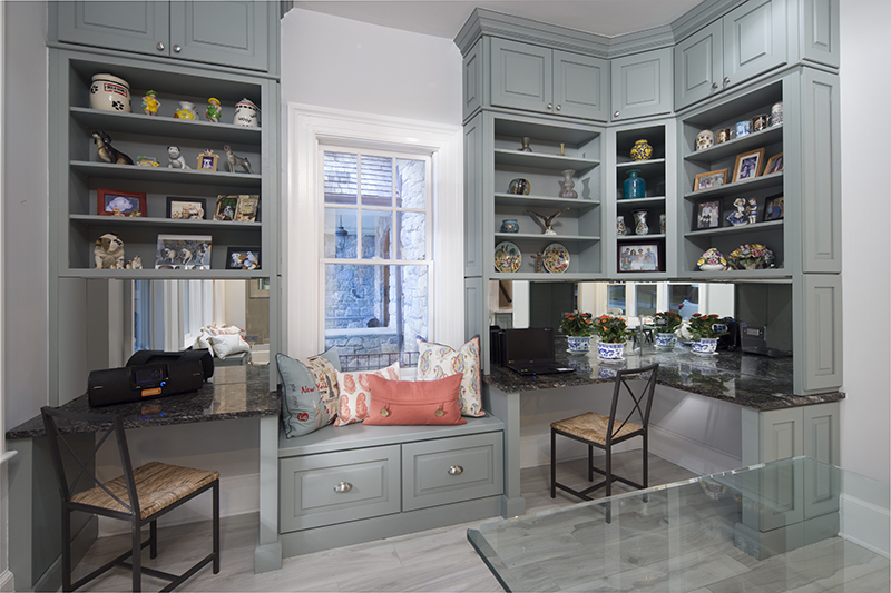 A stunning display, this ground-to-ceiling cabinetry design uses lavish shelving to create a dazzling space.