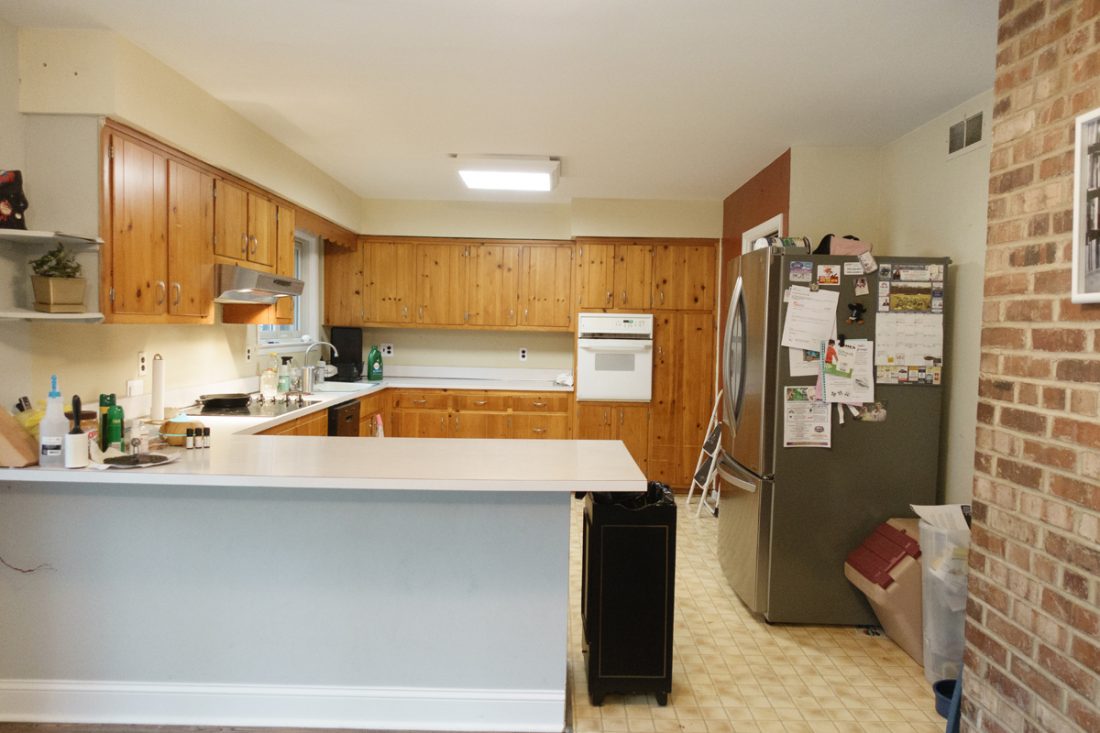 This kitchen was dated with old wood cabinets and a no designated space for the refrigerator