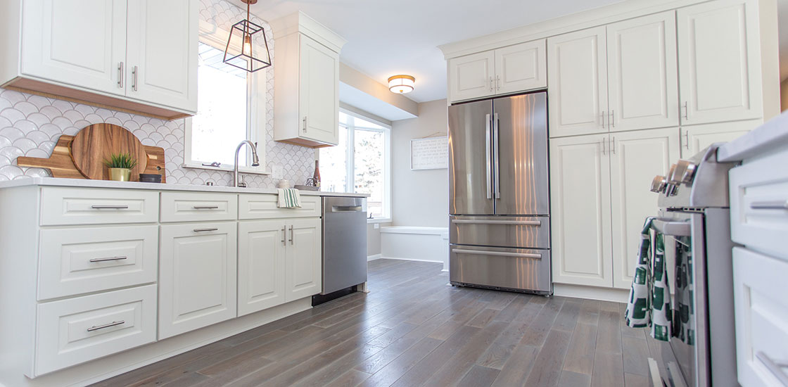 CliqStudios Cambridge kitchen in White showing the work triangle of the sink, refrigerator, and cooktop