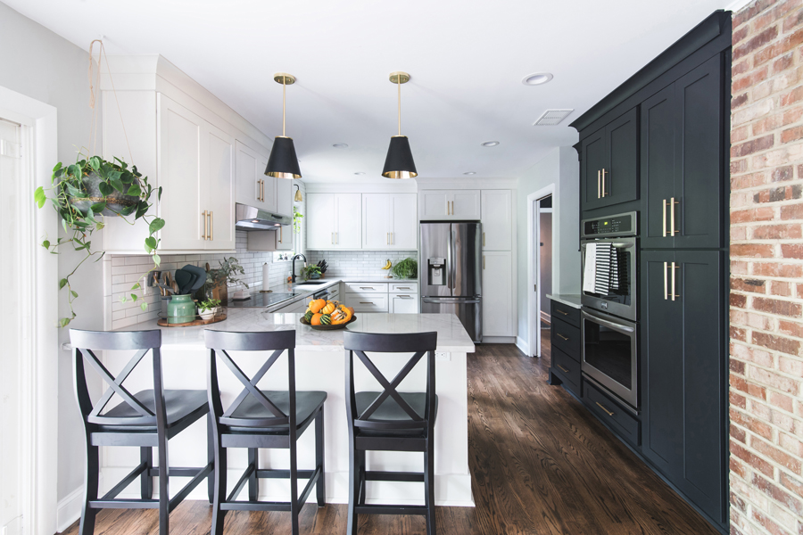 Without major layout changes, this kitchen was transformed with a pantry wall and polished black and white cabinets