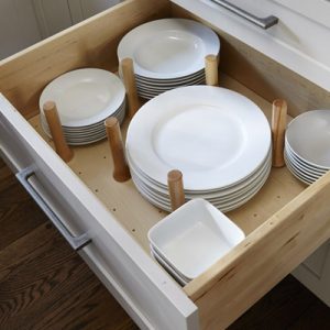 Peg drawer dish organizer inside a white shaker deep cabinet drawer