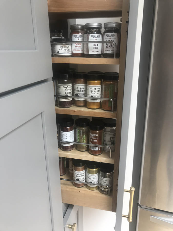 pull-out spice rack with adjustable shelves.