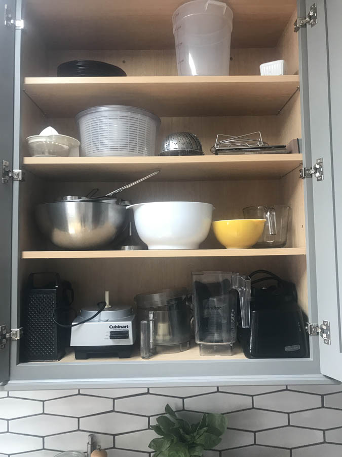 cooking and baking items stored in upper cabinets.