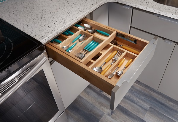 two-tier cutlery drawer open in gray slab door cabinets