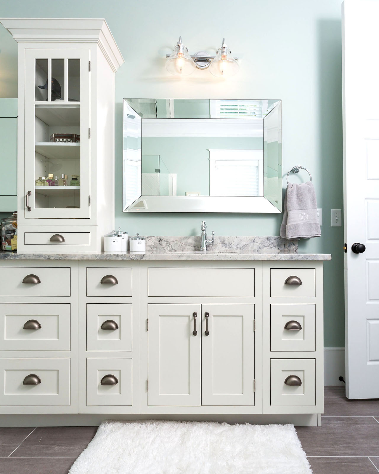 CliqStudios bath cabinets shown in Shaker White door style and finish