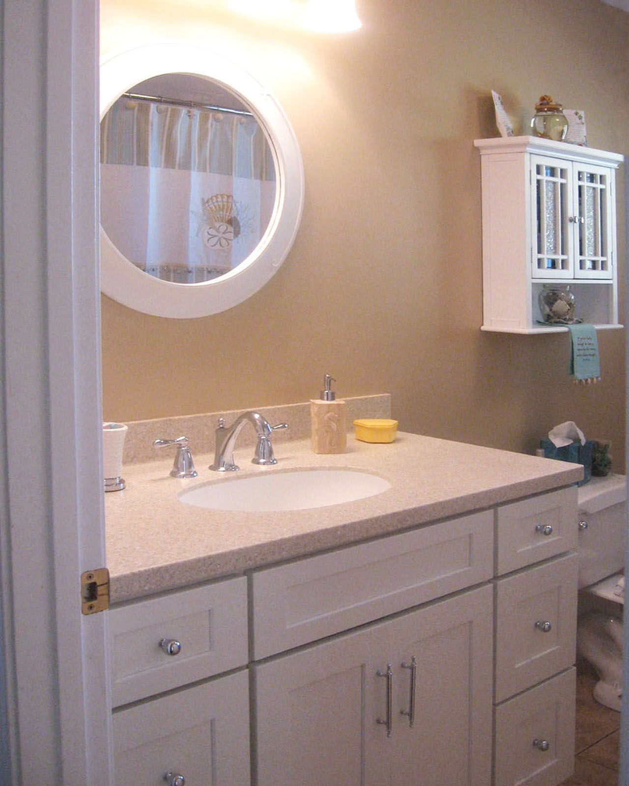 CliqStudios bath cabinets shown in Shaker White door style and finish