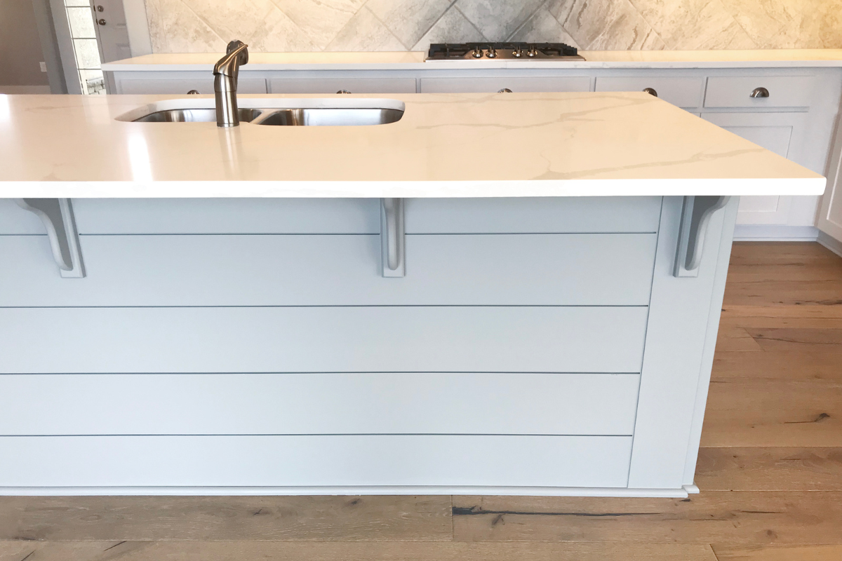 Shiplap kitchen island cabinets with matching corbel countertop supports