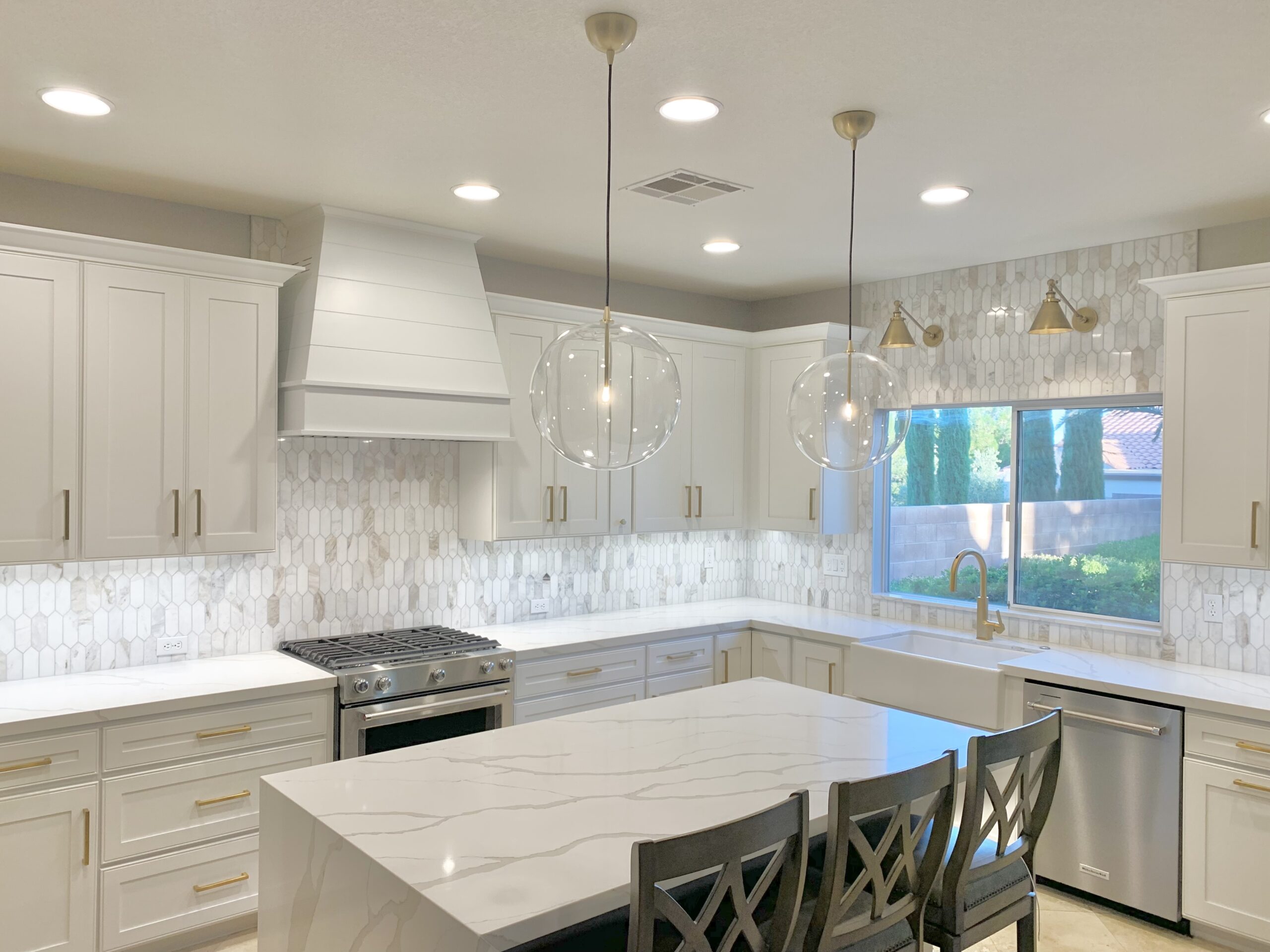 White tapered with shiplap wood range hood in white shaker kitchen