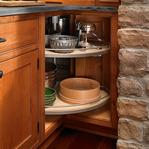 This image is of kitchen corner cabinets & lazy susans. Installing lazy susan spinning trays within the cabinet provides easy access to many items