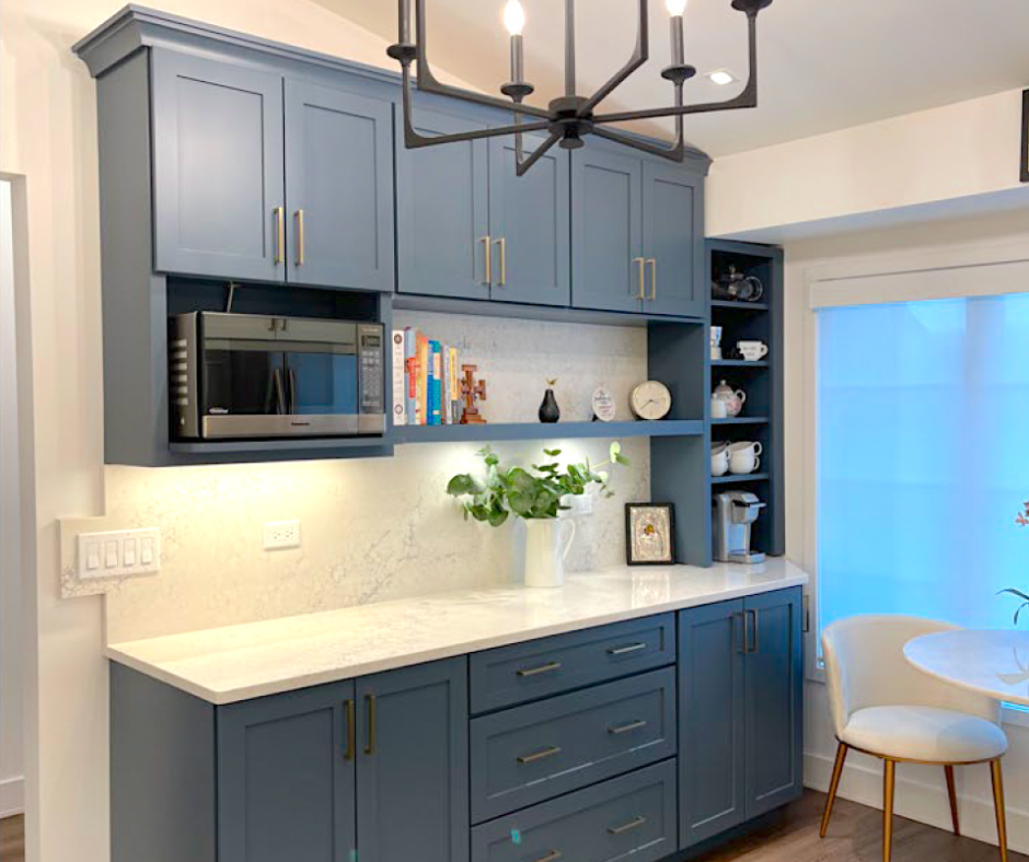 CliqStudios project: Blue shaker kitchen cabinets in a coffee bar with a microwave shelf and light cream colored quartz countertops and backsplash