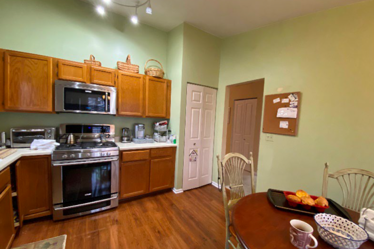 Before photo with golden oak cabinets and light green walls