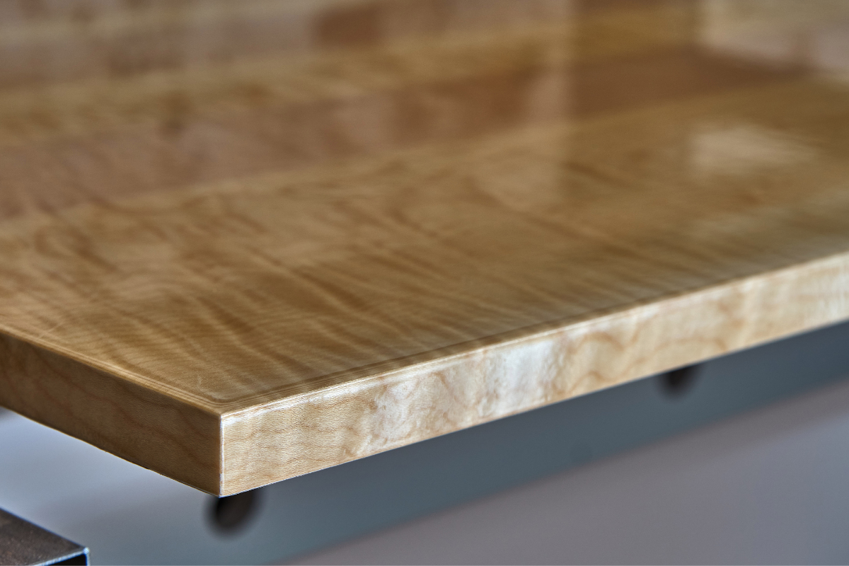 High-gloss wood finish on a large wood panel