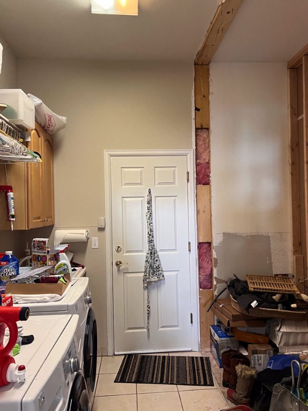 Before photo with a wall torn down on the right that led into the old dining room making space for new laundry room