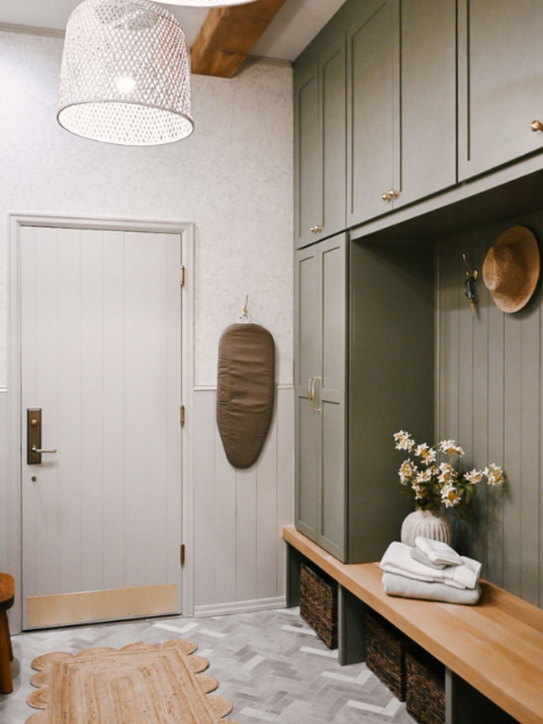 Tall olive green mudroom cabinets with lockers on the outside and a white oak bench for seating on the inside