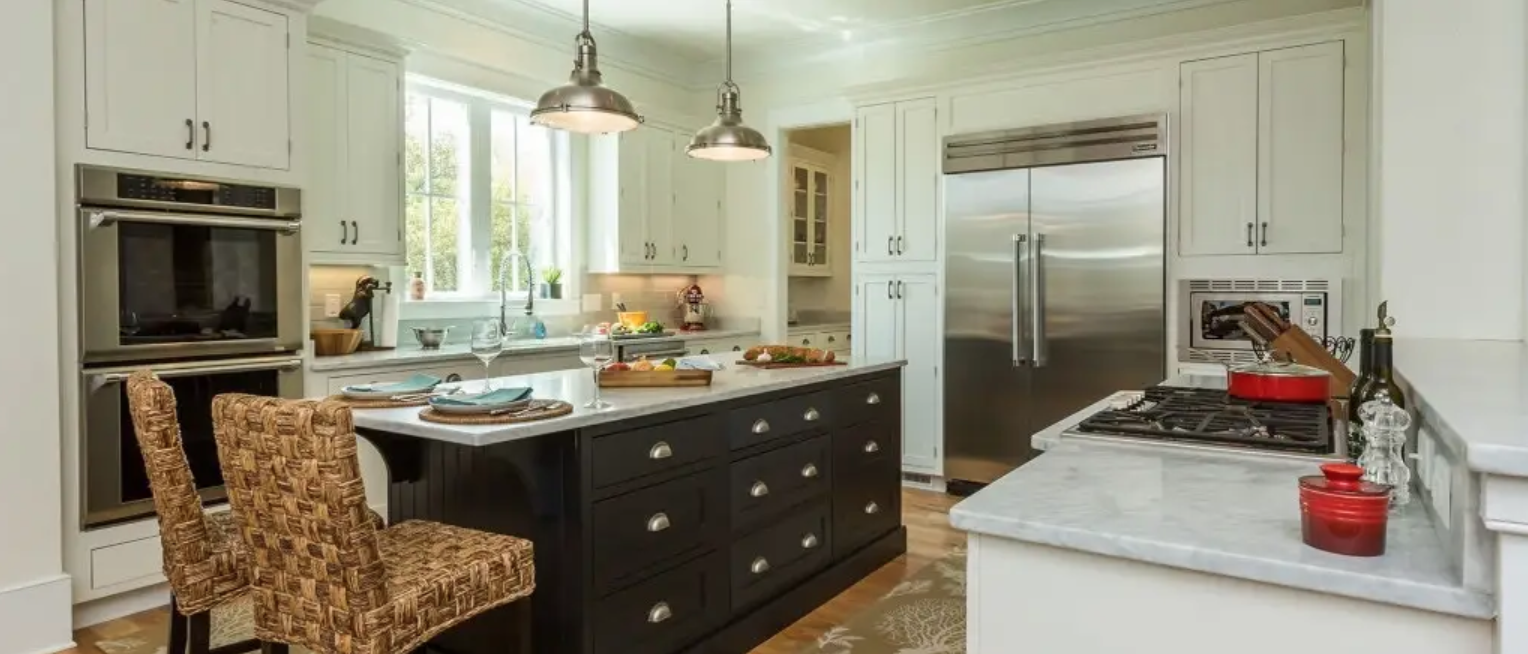 White and black inset shaker kitchen cabinets with marble countertops and chrome farmhouse pendant lighting