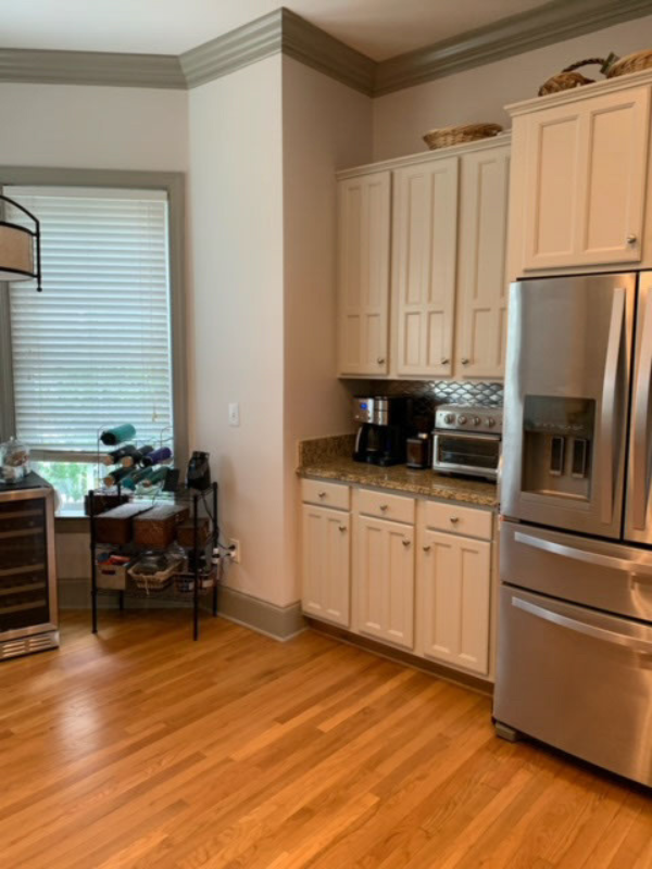 Before photo with older cabinets and an outdated peninsula design