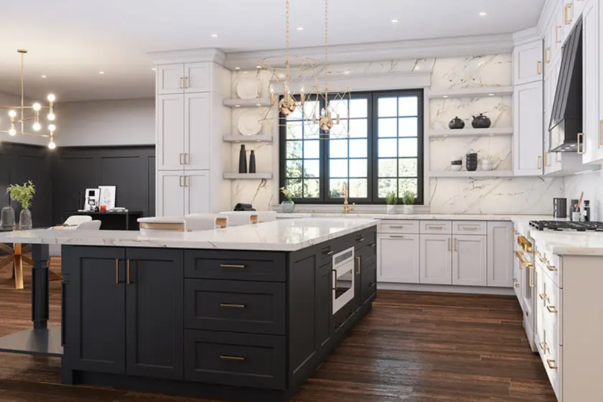 White shaker L-shaped kitchen design with wood floating shelves, gold hardware and lighting and a black shaker island cabinet.