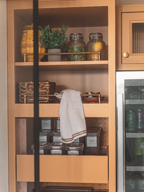 Kitchen pantry cabinets in yellow inset kitchen cabinets with reeded glass and natural stone countertop