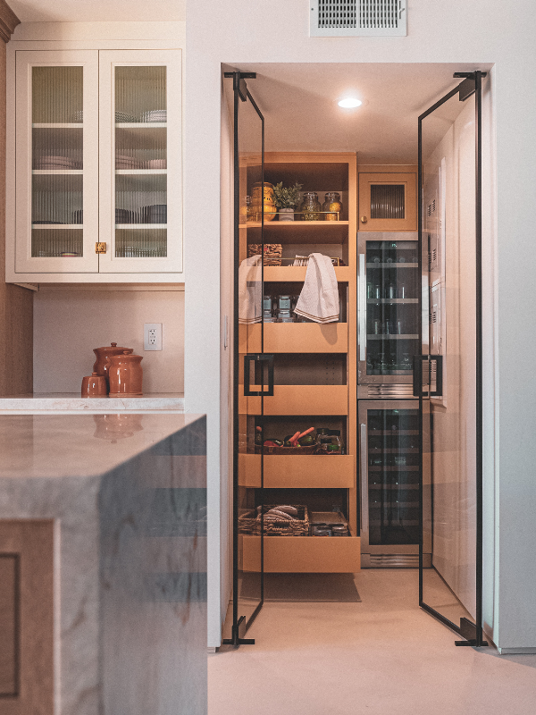 Kitchen pantry cabinets in yellow inset kitchen cabinets with reeded glass and natural stone countertop