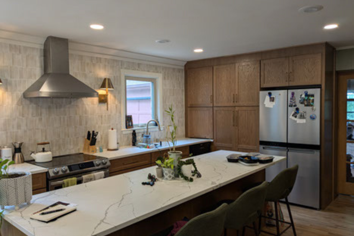 Oak shaker kitchen cabinet design with white quartz countertops and cream colored tile backsplash