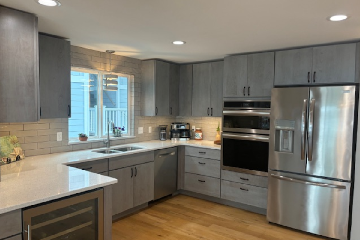 Contemporary gray slab door kitchen with wood floating shelves and white quartz countertops 