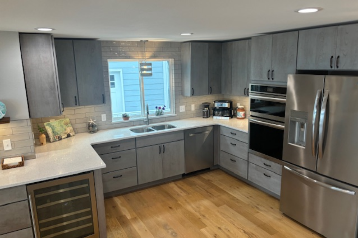 Contemporary gray slab door kitchen with wood floating shelves and white quartz countertops 