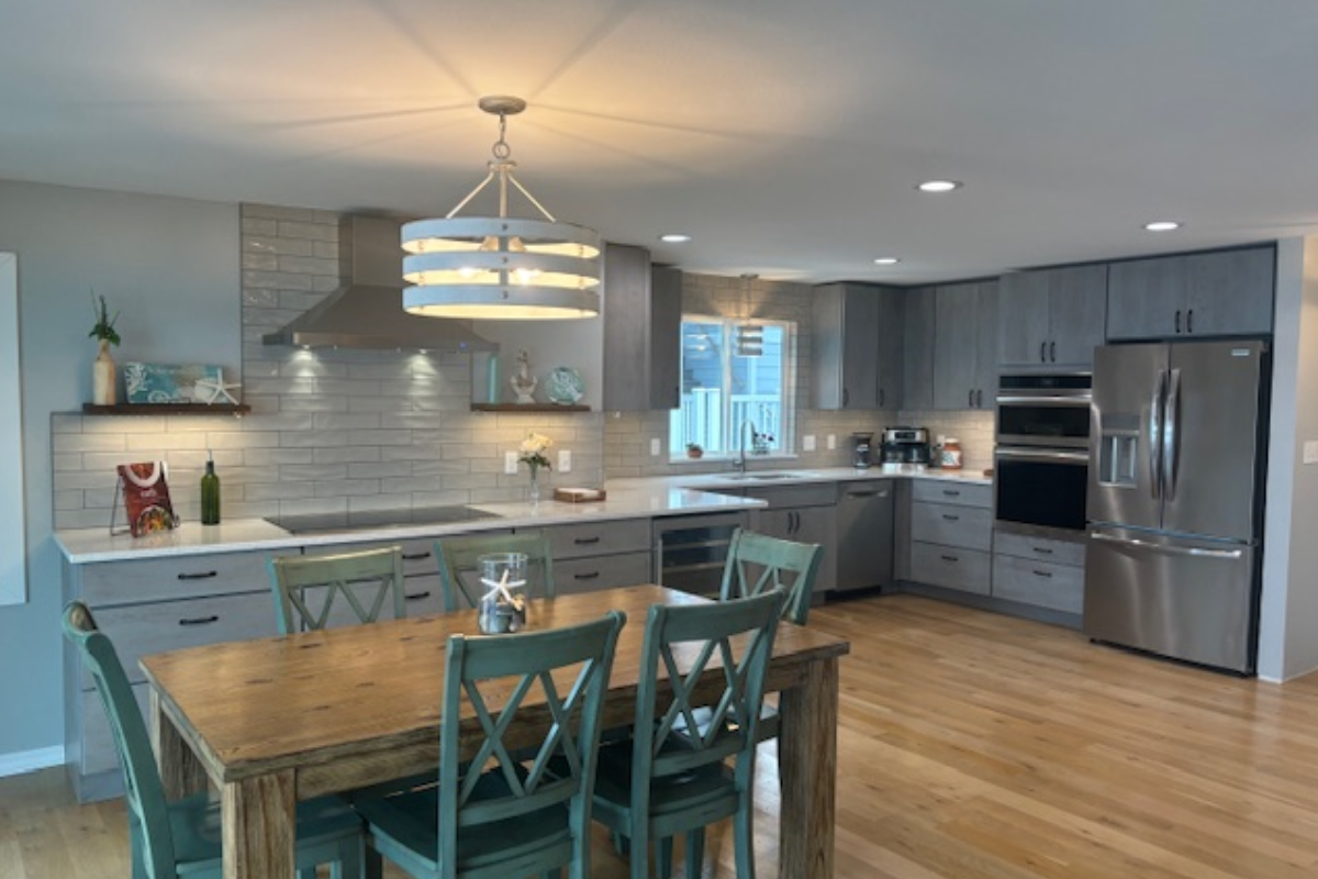 Contemporary gray slab door kitchen with wood floating shelves and white quartz countertops 