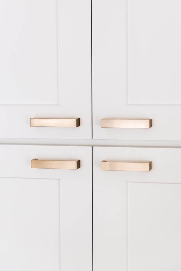 four gold cabinet hardware door pulls on white cabinets