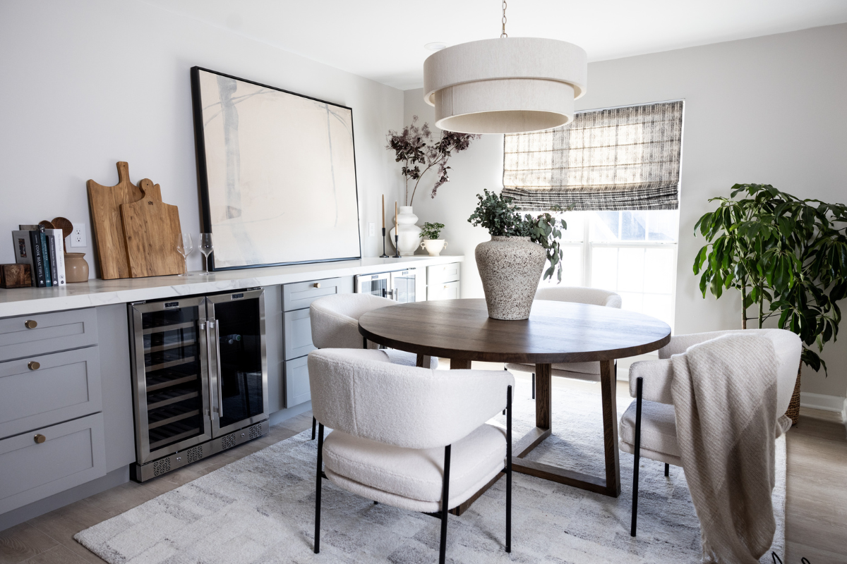 Built-in dining room sideboard in light gray shaker base cabinets with gold cabinet hardware and white quartz countertops