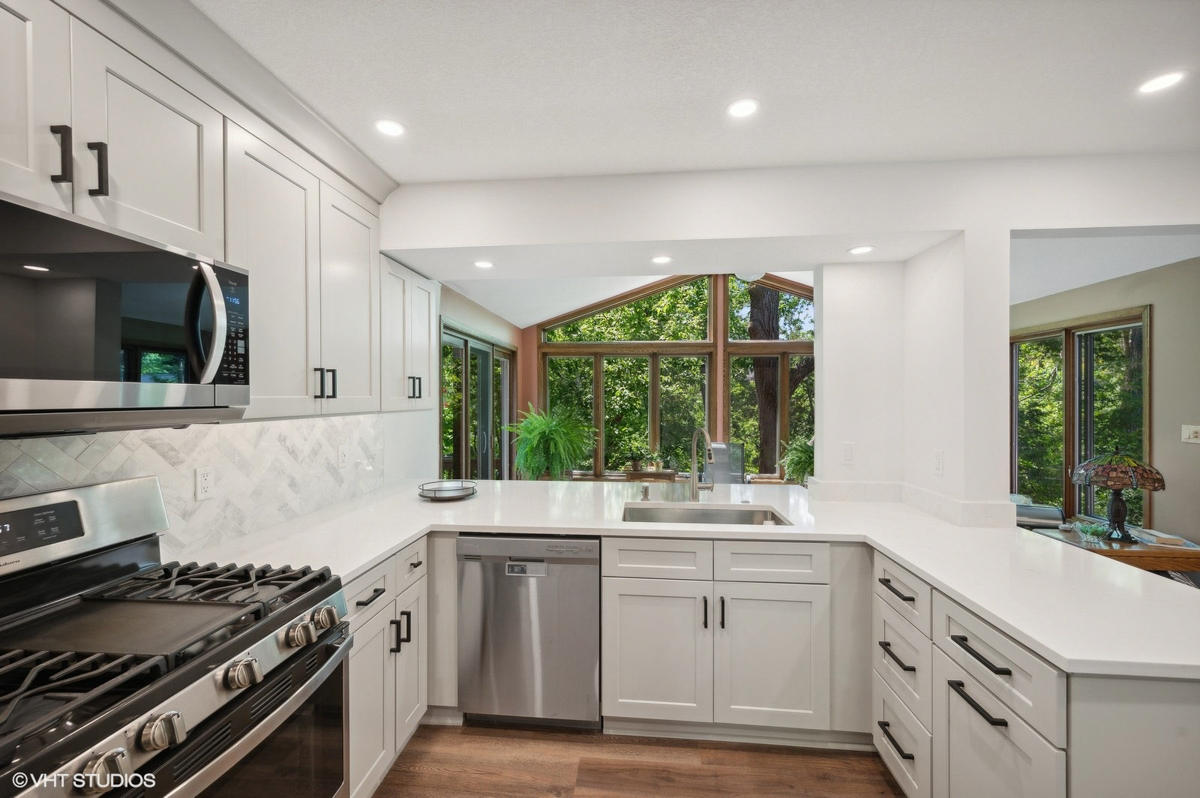 Light gray shaker kitchen cabinets with peninsula design 