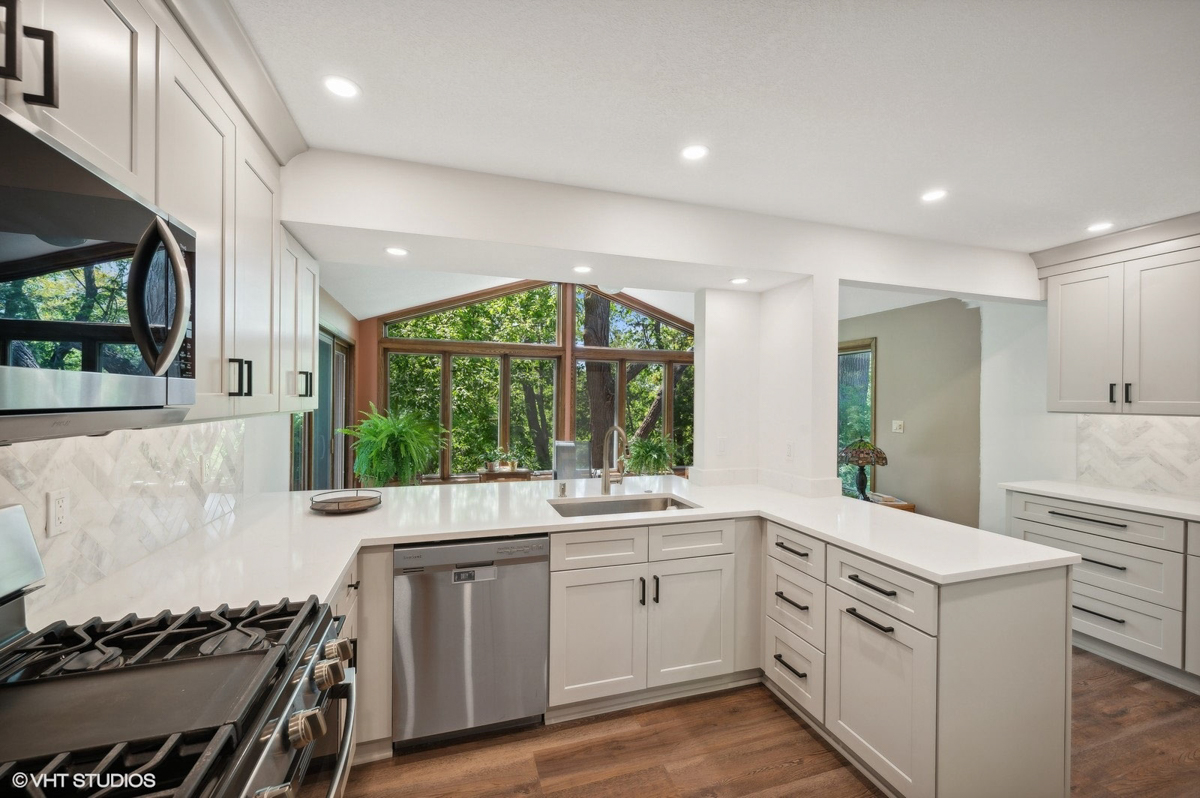 Light gray shaker kitchen cabinets with peninsula design 