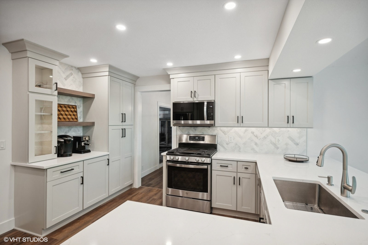 Light gray shaker kitchen cabinets with peninsula design 